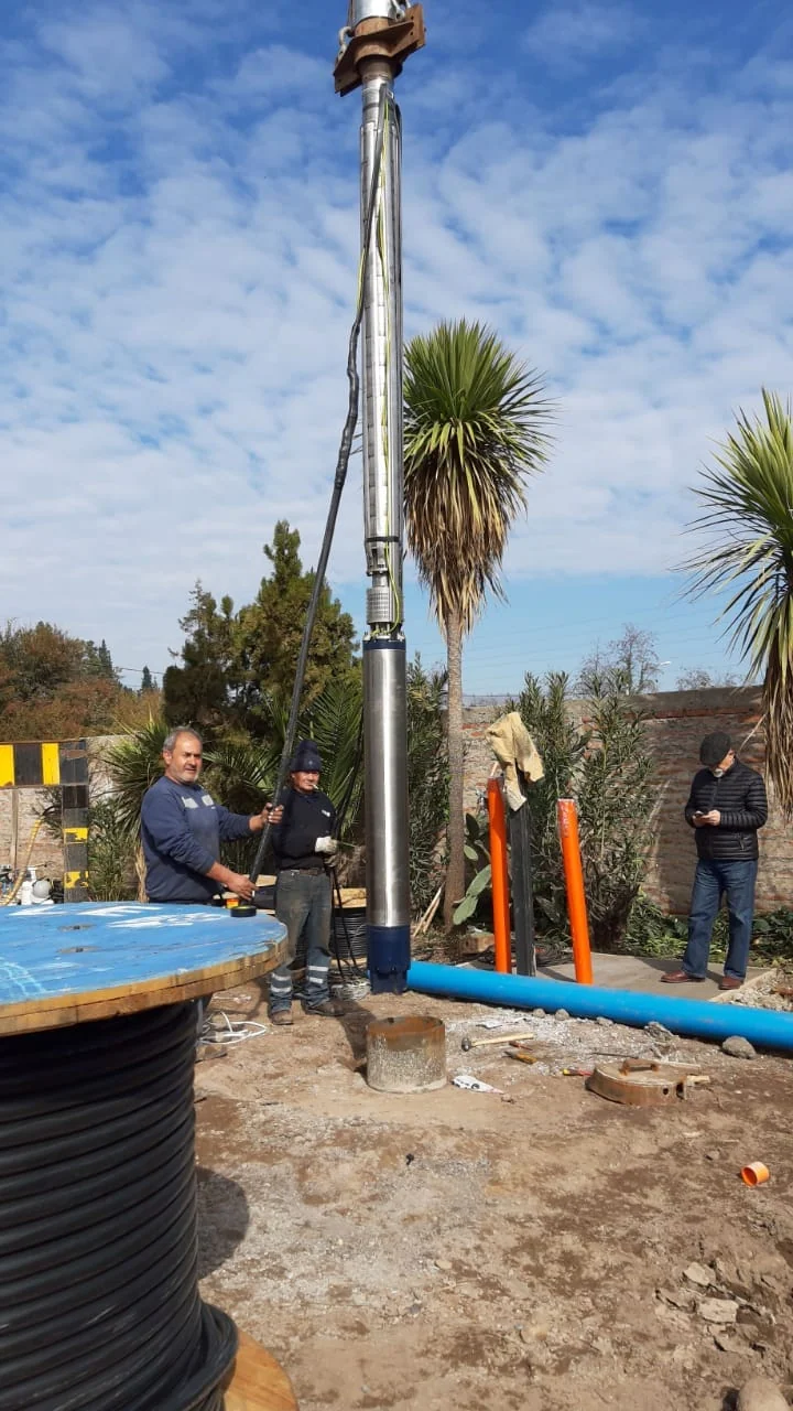 Equipo de trabajo instalando una bomba de captación en terreno